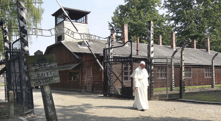 Pope Francis walks through the gate of the former Nazi German death camp of Auschwitz in Oswiecim, Poland, Friday, July 29, 2016. Pope Francis paid a somber visit to the Nazi German death camp of Ausc ...