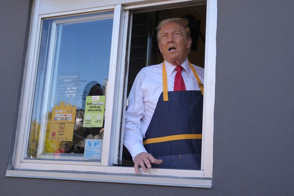 Republican presidential nominee former President Donald Trump speaks from a drive-thru window during a campaign stop at a McDonald&#039;s, Sunday, Oct. 20, 2024, in Feasterville-Trevose, Pa. (AP Photo ...