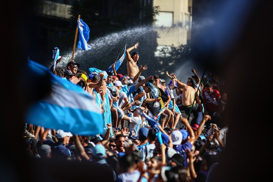 December 20, 2022, Buenos Aires, Argentina: Argentinian fans seen during the celebrations in the Plaza de Mayo. More than 4 million people invaded the city of Buenos Aires to celebrate the world cup o ...