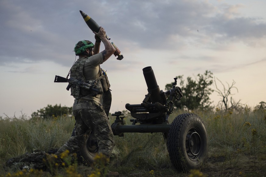 FILE - A Ukrainian serviceman of the 3rd Assault Brigade fires a 122mm mortar towards Russian positions at the front line, near Bakhmut, Donetsk region, Ukraine, Sunday, July 2, 2023. Fighting has int ...