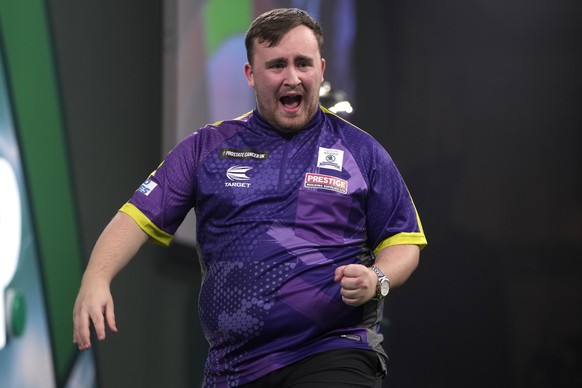 Luke Littler of England celebrates winning a set during the final match against Luke Humphries of England at the World Darts Championship, in London, Wednesday, Jan. 3, 2024. (AP Photo/Kin Cheung)