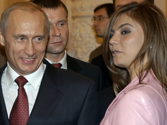 FILE - In this Thursday, Nov. 4, 2004 file photo President Vladimir Putin, left, speaks with gymnast Alina Kabaeva at a Kremlin banquet in Moscow, Russia. Alina Kabayeva, the Olympic gold gymnast whos ...