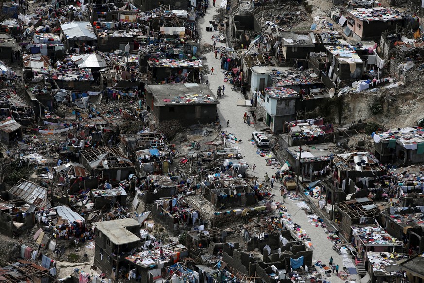 People walk on a street next to destroyed houses after Hurricane Matthew hit Jeremie, Haiti, October 6, 2016. REUTERS/Carlos Garcia Rawlins TPX IMAGES OF THE DAY