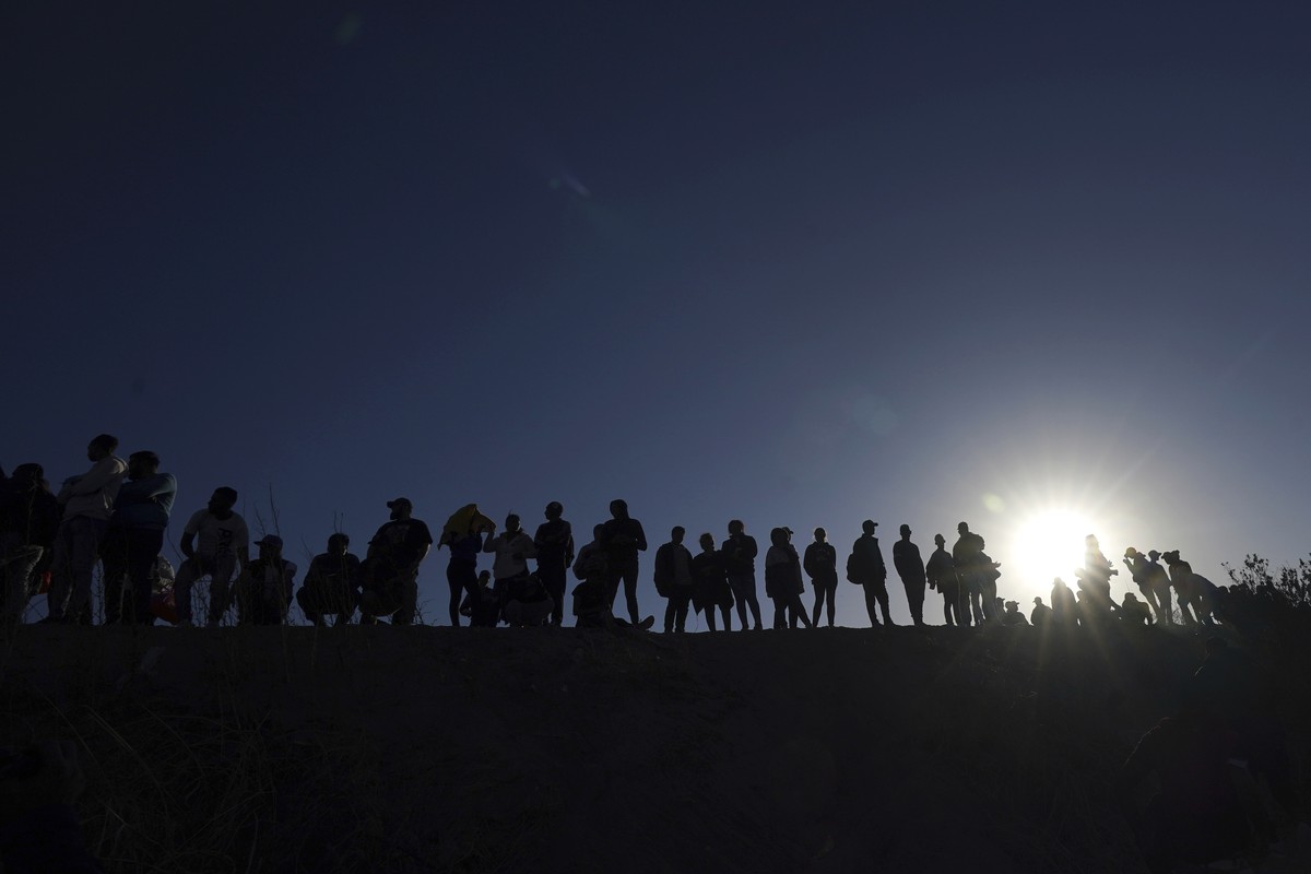 FILE - Migrants stand on the Mexican side of the U.S.-Mexico border, on the banks of the Rio Grande, in Ciudad Juarez, Mexico, March 29, 2023. About 50 migrants have been kidnapped by a gang in northe ...