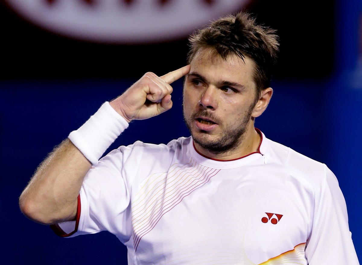 Stanislas Wawrinka of Switzerland celebrates a point won against Rafael Nadal of Spain in the men's singles final at the Australian Open tennis championship in Melbourne, Australia, Sunday, Jan.  ...