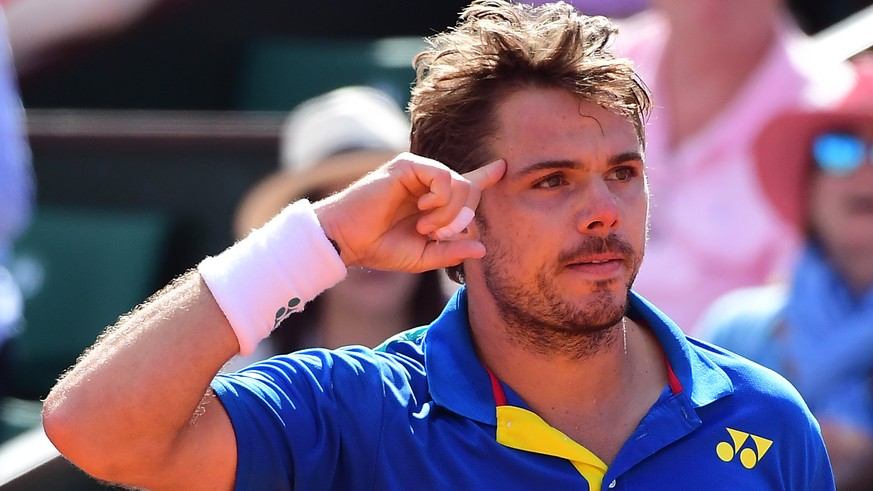 epa06019132 Stanislas Wawrinka of Switzerland reacts as he plays against Andy Murray of Britain during their men’s singles semi final match during the French Open tennis tournament at Roland Garros in ...