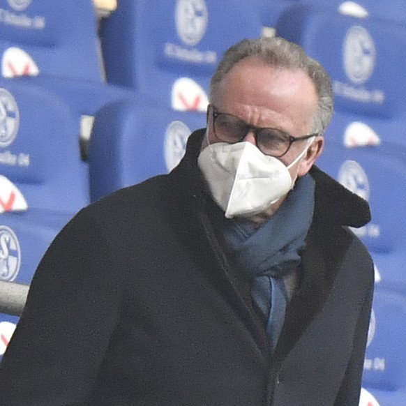 Bayern President Karl-Heinz Rummenigge, right, sits on the stands prior to the start of the German Bundesliga soccer match between FC Schalke 04 and Bayern Munich in Gelsenkirchen, Germany, Sunday, Ja ...