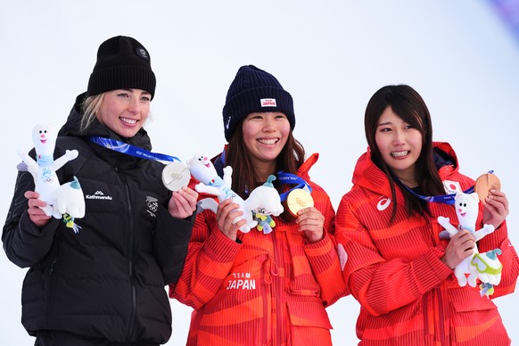 From left, silver medalist New Zealand's Zoi Sadowski-Synnott, gold medalist Japan's Mari Fukada and bronze medalist Japan's Kokomo Murase hold their medals after the women's snowb ...
