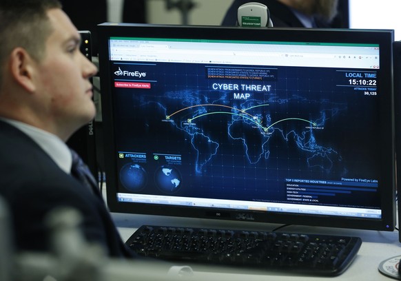 A Department of Homeland Security worker listens to U.S. President Barack Obama talk at the National Cybersecurity and Communications Integration Center (NCCIC) in Arlington, Virginia, in this January ...