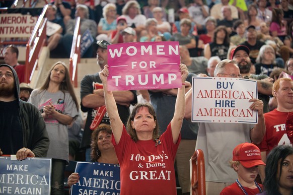 epa05936316 A supporter of US President Donald J. Trump holds up a &#039;Women for Trump&#039; banner during a rally at the Pennsylvania Farm Show Complex in Harrisburg, Pennsylvania, USA, 29 April 20 ...