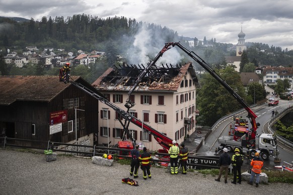 epa13182442 Firefighters try to put out a fire at a building with a restaurant and apartments in Thusis in eastern Switzerland, 21 August 2026. Five people are reported missing following a major fire, ...