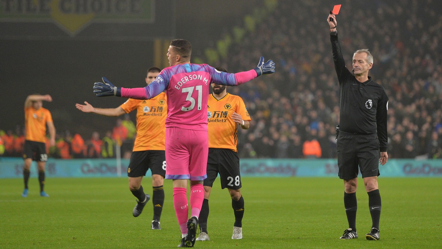 epa08092131 Referee Martin Atkinson sent off Manchester City goalkeeper Ederson (C) during the English Premier league soccer match between Wolverhampton Wanderers and Manchester City held at the Molin ...