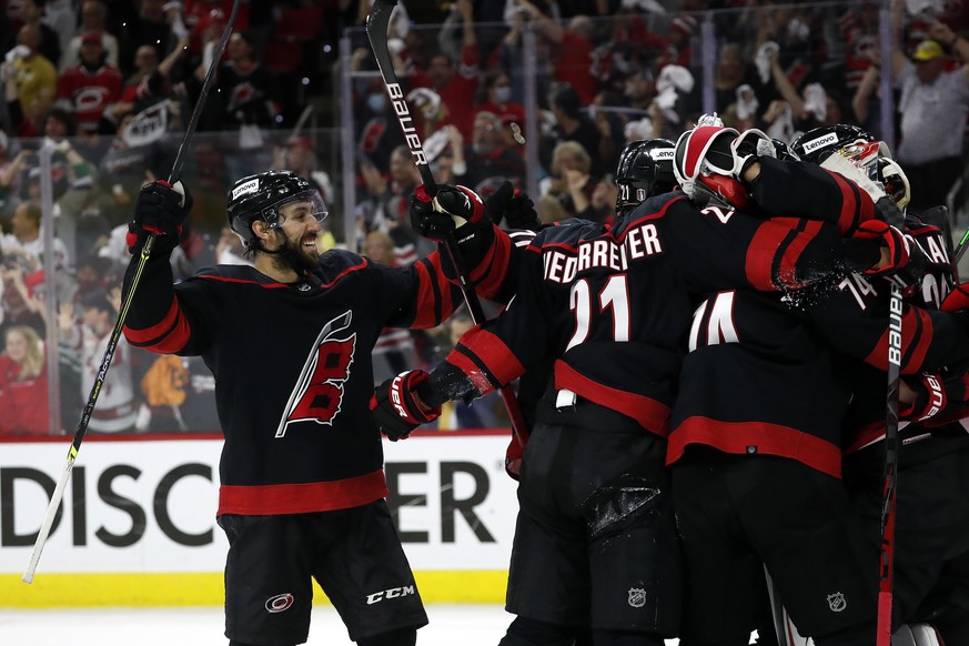 Carolina Hurricanes&#039; Vincent Trocheck (16) joins the celebration around goaltender Antti Raanta following their win over the Boston Bruins in Game 7 of an NHL hockey Stanley Cup first-round playo ...