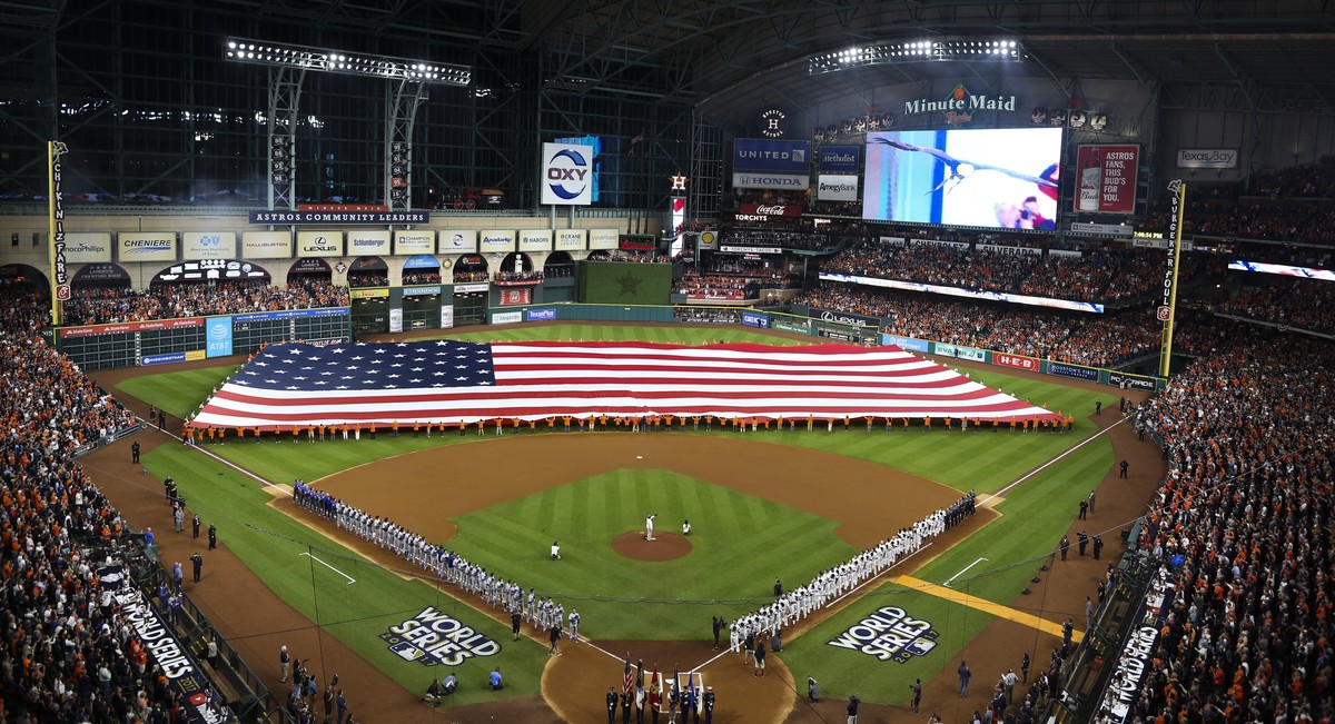 Teams line up for the national anthem before Game 3 of baseball's World Series between the Houston Astros and the Los Angeles Dodgers Friday, Oct. 27, 2017, in Houston. (AP Photo/Tim Donnelly)