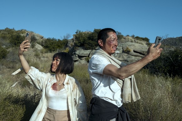 This image released by Netflix shows Ali Wong, left, and Steven Yeun in a scene from &quot;Beef.&quot; (Andrew Cooper/Netflix via AP)