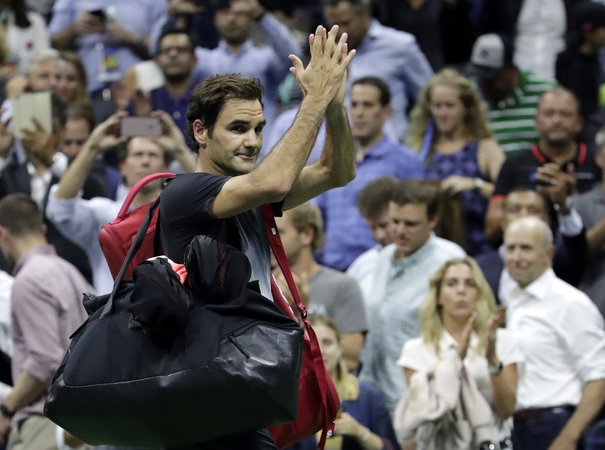 Roger Federer, of Switzerland, acknowledges spectators while leaving the court after losing to Juan Martin del Potro, of Argentina, during the quarterfinals of the U.S. Open tennis tournament, Wednesd ...