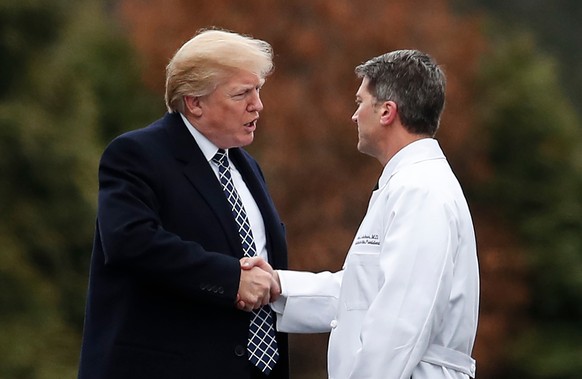 FILE - In this Friday, Jan. 12, 2018 file photo, President Donald Trump shakes hands with White House physician Dr. Ronny Jackson as he boards Marine One to leave Walter Reed National Military Medical ...