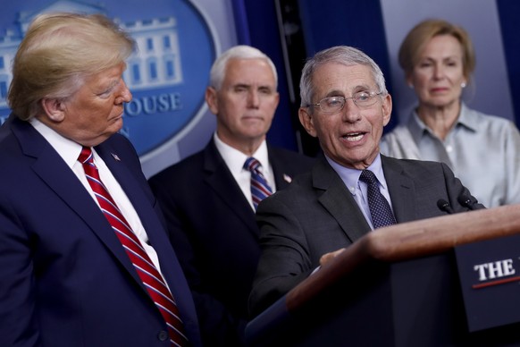 epa08310340 Anthony Fauci, director of the National Institute of Allergy and Infectious Diseases, speaks as US President Donald Trump, left, listens during a Coronavirus Task Force news conference in  ...