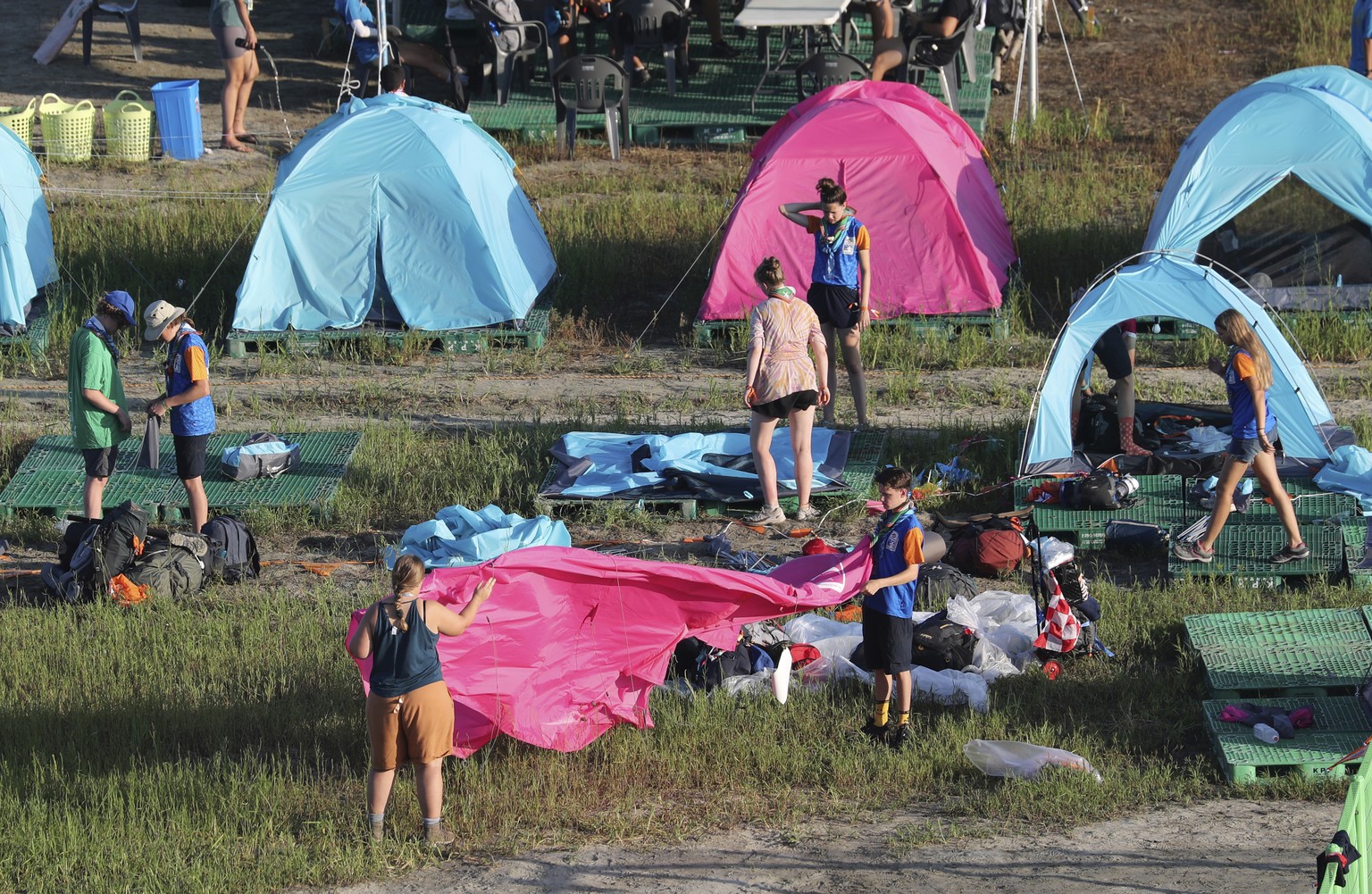 Attendees of the World Scout Jamboree prepare to leave a scout camping site in Buan, South Korea, Tuesday, Aug. 8, 2023. South Korea will evacuate tens of thousands of scouts by bus from a coastal jam ...