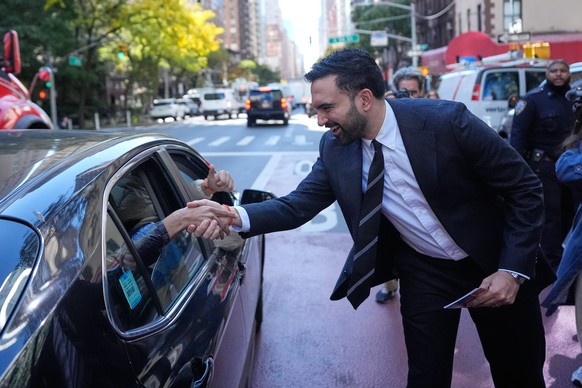 New York City mayoral candidate Zohran Mamdani greets some people in a car while surrounded by reporters in New York, Monday, Oct. 27, 2025. (AP Photo/Seth Wenig)
Zohran Mamdani