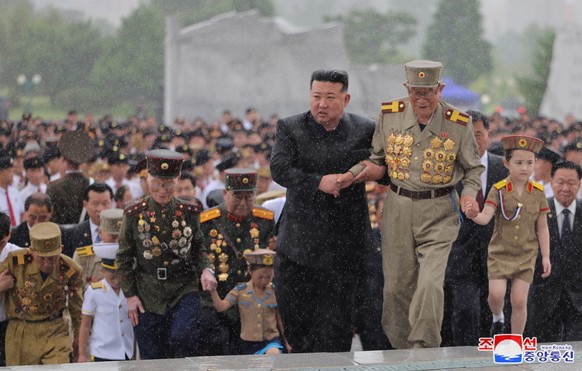 epa11498464 A photo released by the official North Korean Central News Agency (KCNA) shows North Korean leader Kim Jong Un (C) visiting the Fatherland Liberation War Martyrs Cemetery on the 71st anniv ...