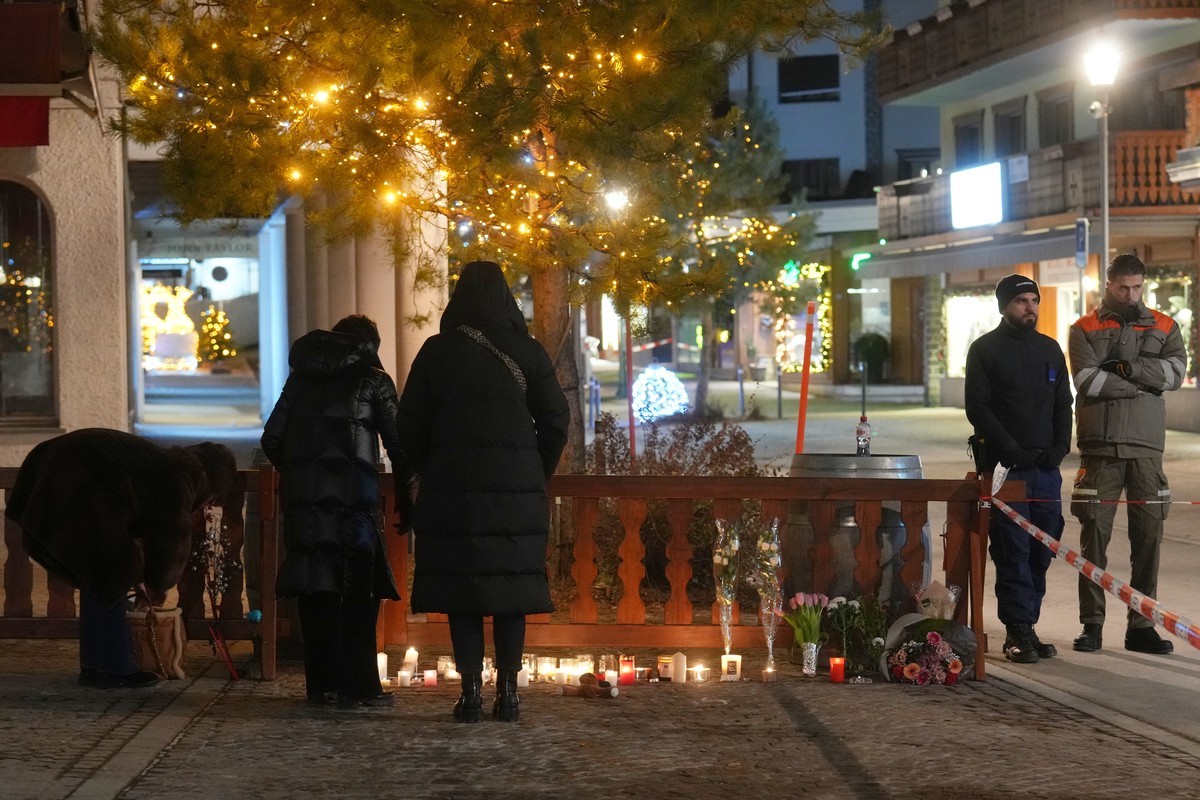 People have laid candles and flowers near the Le Constellation bar, where a devastating fire left dead and injured during the New Year's celebrations in Crans-Montana, Swiss Alps, Switzerland, Th ...