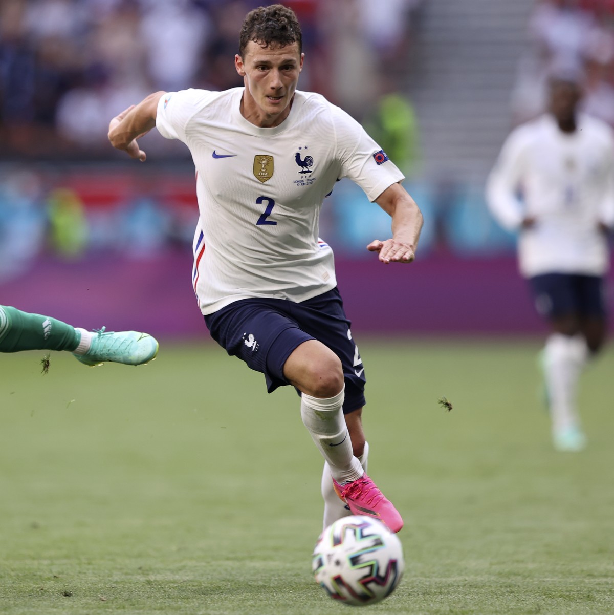 Hungary's Roland Sallai is airborne as he challenges for the ball with France's Benjamin Pavard during the Euro 2020 soccer championship group F match between Hungary and France, at the Fere ...