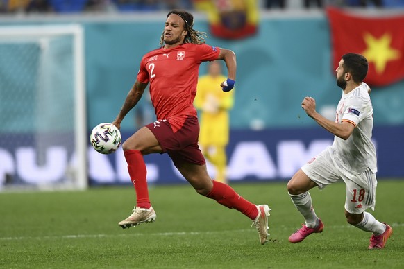 Switzerland&#039;s Kevin Mbabu goes for the ball ahead of Spain&#039;s Jordi Alba during the Euro 2020 soccer championship quarterfinal match between Switzerland and Spain, at the Saint Petersburg sta ...