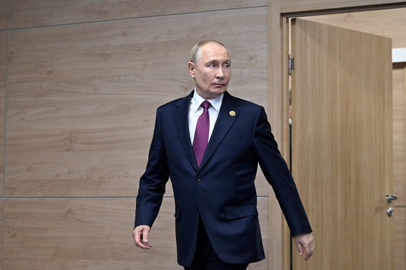 epa11681544 Russian President Vladimir Putin arrives to greet guests during bilateral meetings on the sidelines of the BRICS summit in Kazan, 24 October 2024. The BRICS summit takes place from 22 to 2 ...