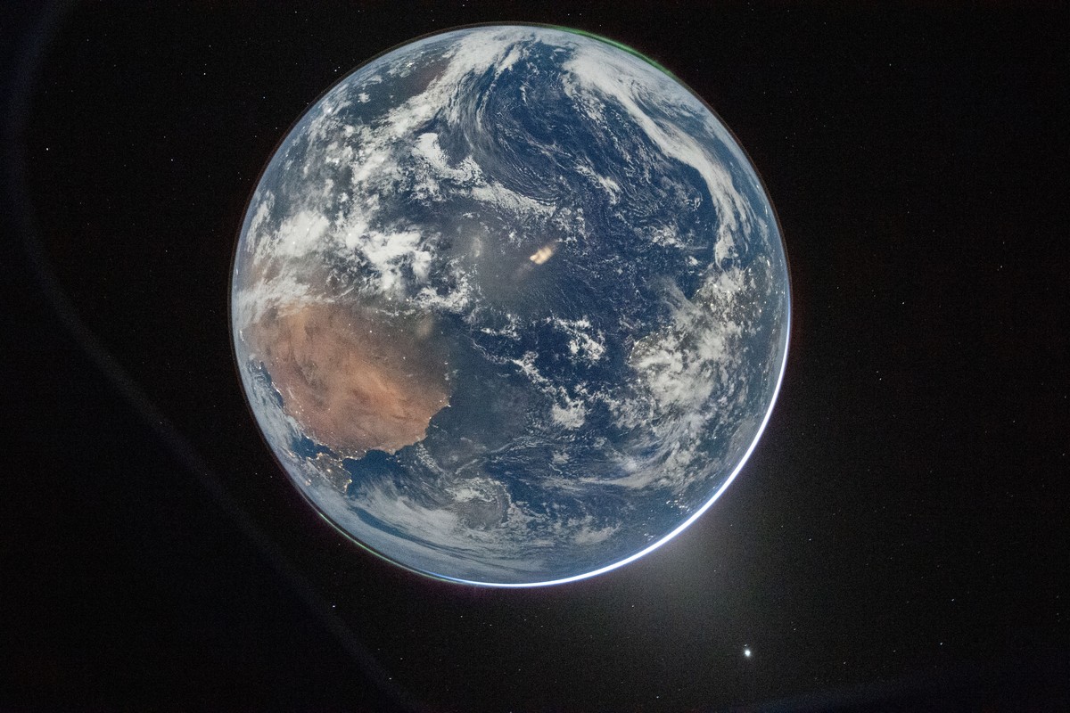 This image provided by NASA shows a view of Earth taken by NASA astronaut and Artemis II Commander Reid Wiseman from of the Orion spacecraft's window after completing the translunar injection bur ...