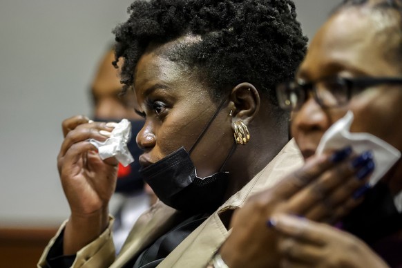 Ahmaud Arbery's sister Jasmine Arbery wipes a tear from her eyes while listening to her mother's impact statement to Superior Court Judge Timothy Walmsley during the sentencing of Greg McMichael and h ...