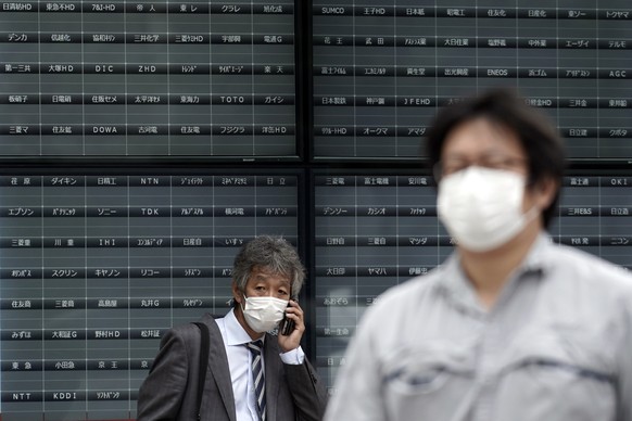 A man stands in front of a blank electronic stock board supposedly showing Japan&#039;s Nikkei 225 index at a securities firm in Tokyo Thursday, Oct. 1, 2020. Trading on the Tokyo Stock Exchange was s ...