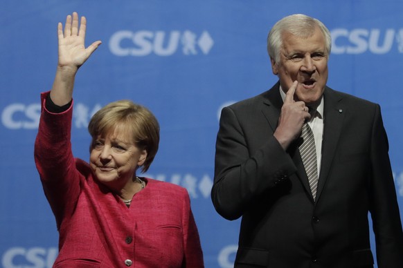 FILE - In this Sept. 22, 2017 file photo German Chancellor and Christian Democratic Union (CDU) party chairwoman Angela Merkel waves after her speech at an election campaign rally besides Bavarian sta ...