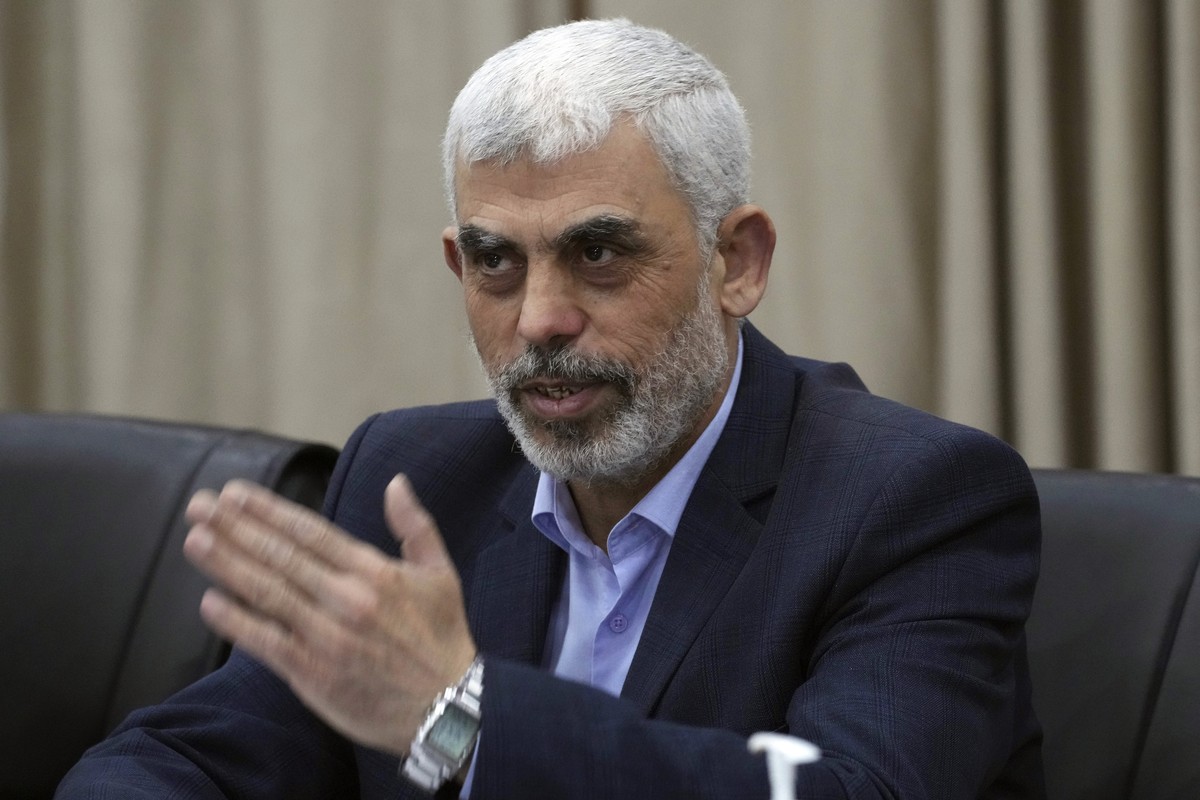 Yehia Sinwar, head of Hamas in Gaza, greets his supporters during a meeting with leaders of Palestinian factions at his office in Gaza City, Wednesday, April 13, 2022. The chief prosecutor of the Inte ...