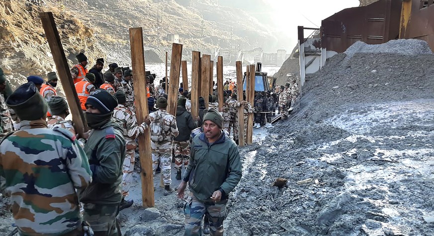 Indo Tibetan Border Police (ITBP) personnel undertake rescue work at one of the hydro power project at Reni village in