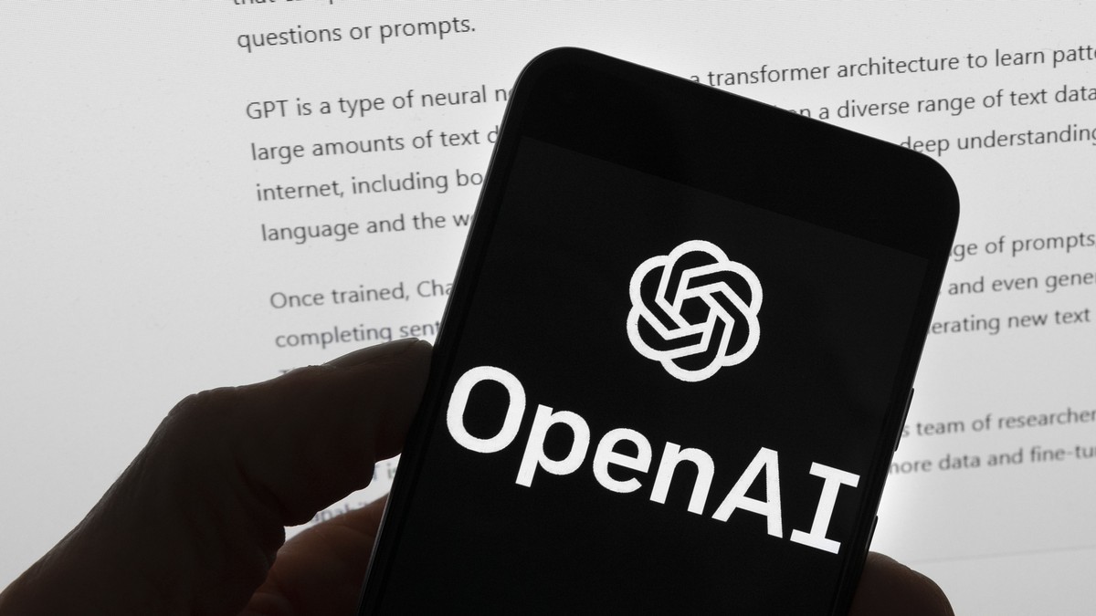 FILE - The OpenAI logo is seen on a mobile phone in front of a computer screen which displays output from ChatGPT, Tuesday, March 21, 2023, in Boston. White House officials concerned about AI chatbots ...
