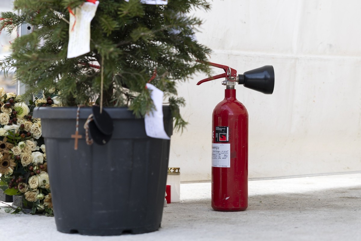 A fire extinguisher are pictured to the memorial for the victims after the fire at the "Le Constellation" bar and lounge, in Crans-Montana, Switzerland, Monday, February 9, 2026. 41 people m ...