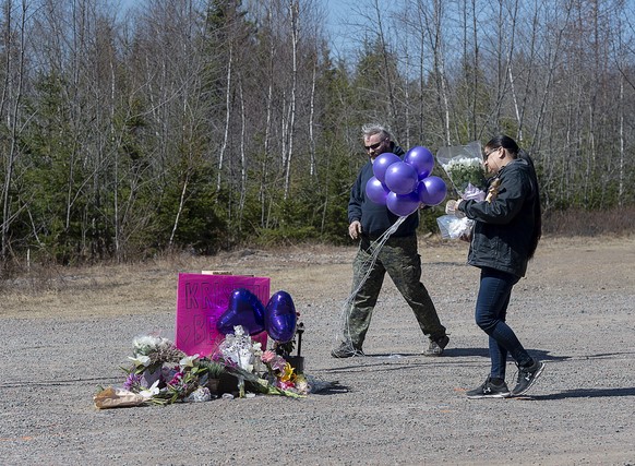 A memorial pays tribute to health-care worker Kristen Beaton along the highway in Debert, Nova Scotia, on Tuesday, April 21, 2020. Canadian police are investigating at 16 crime scenes after a weekend  ...