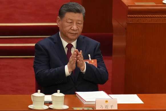 Chinese President Xi Jinping applauds during the closing session of the National People's Congress (NPC) at the Great Hall of the People in Beijing, Thursday, March 12, 2026. (AP Photo/Ng Han Gua ...