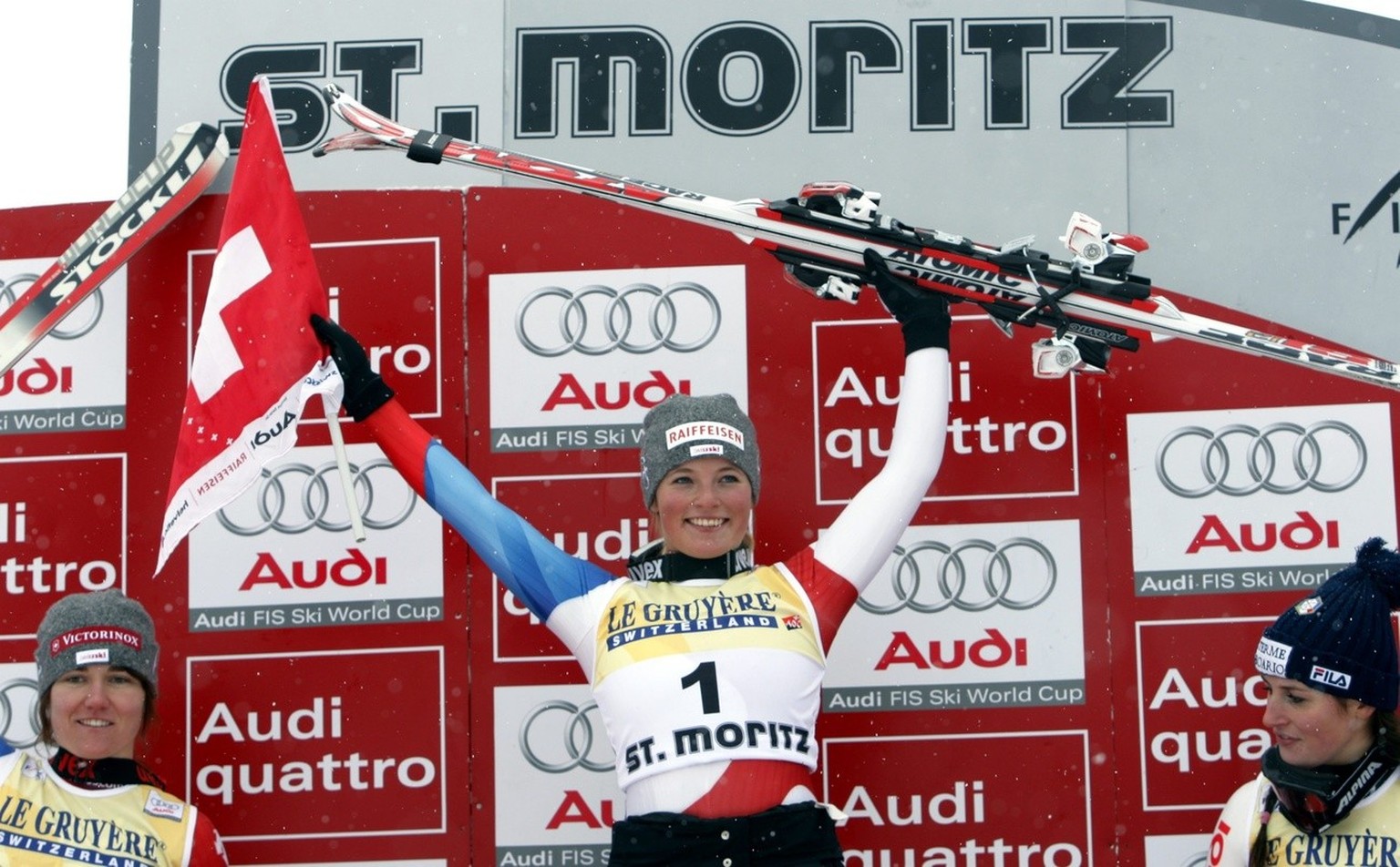 Lara Gut, of Switzerland, center, winner of the alpine ski, Women&#039;s World Cup super-G race, stands on the podium with second placed Fabienne Suter, of Switzerland, left, and third placed Nadia Fa ...