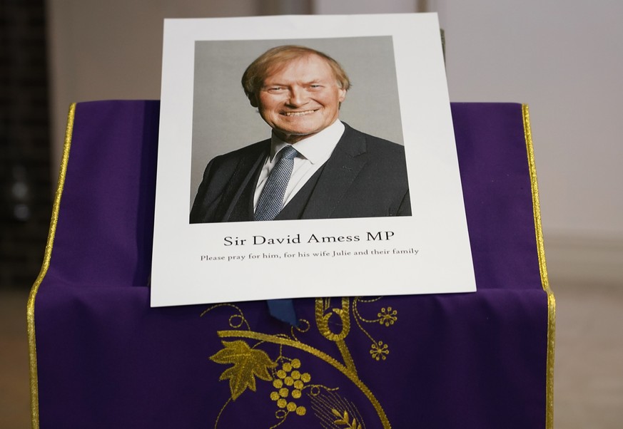 An image of murdered British Conservative lawmaker David Amess is displayed near the altar in St Peters Catholic Church before a vigil in Leigh-on-Sea, Essex, England, Friday, Oct. 15, 2021. Amess die ...