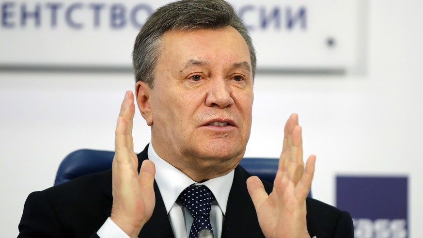 FILE - In this March 2, 2018 file photo, former Ukraine President Viktor Yanukovych gestures as he speaks at a news conference in Moscow. A court in the Ukrainian capital Kiev on Thursday Jan. 24, 201 ...