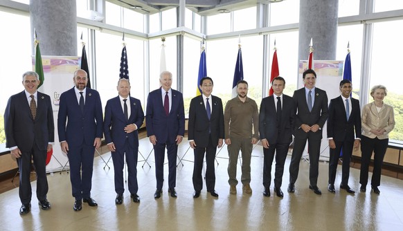 President Joe Biden, fourth left, and Ukrainian President Volodymyr Zelenskyy, fifth right, and other G7 leaders pose for a photo for a working session on Ukraine during the G7 summit in Hiroshima, ...