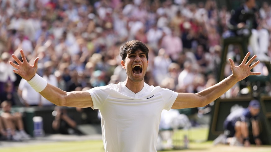 Carlos Alcaraz of Spain celebrates after defeating Novak Djokovic of Serbia in the men&#039;s singles final at the Wimbledon tennis championships in London, Sunday, July 14, 2024. (AP Photo/Alberto Pe ...