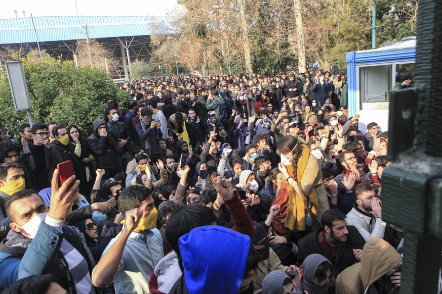 FILE - In this Saturday, Dec. 30, 2017 file photo taken by an individual not employed by the Associated Press and obtained by the AP outside Iran, university students attend a protest inside Tehran Un ...