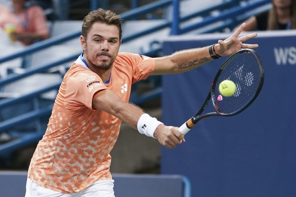 Stan Wawrinka, of Switzerland, returns to Marton Fucsovics, of Hungary, at the Western &amp; Southern Open tennis tournament Thursday, Aug. 16, 2018, in Mason, Ohio. (AP Photo/John Minchillo)