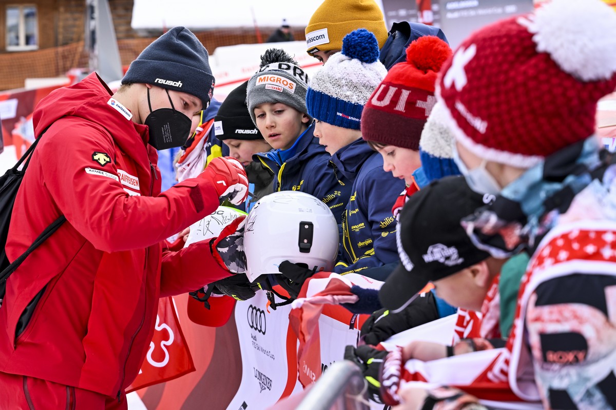 Winner Marco Odermatt of Switzerland signs autographs for the children after the men's giant slalom race at the Alpine Skiing FIS Ski World Cup in Adelboden, Switzerland, Saturday, January 8, 202 ...