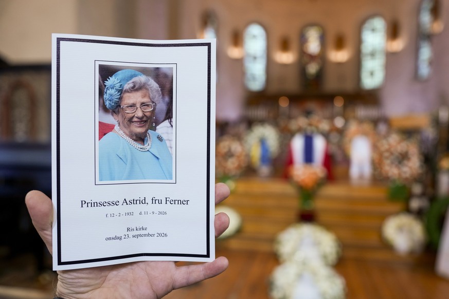 epa13257219 A guest display the program during the funeral of princess Astrid at Ris Church in Oslo, Norway, 23 September 2026. Norway's Princess Astrid, the older sister of the late King Harald, ...