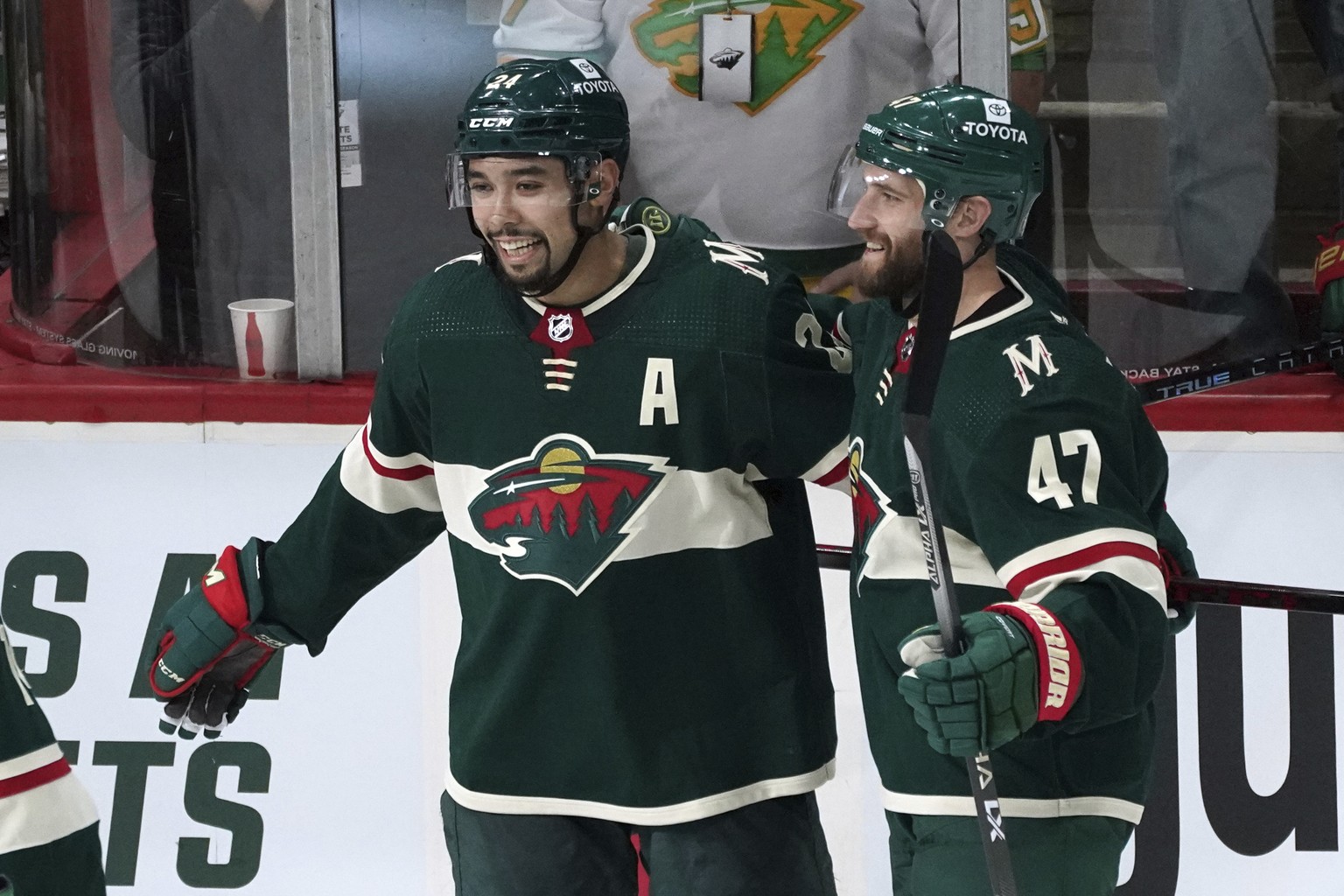 Minnesota Wild&#039;s Alex Goligoski (47) and Matt Dumba, left, celebrate Dumba&#039;s go-ahead goal in the third period off Vegas Golden Knights goalie Logan Thompson in an NHL hockey game, Monday, M ...