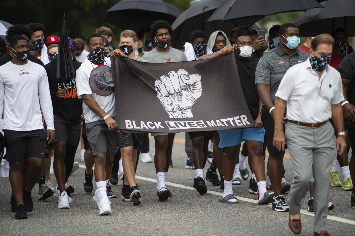 The University of Alabama football team features a Black Lives Matter flag as they march on campus in support of the Black Lives Matter movement, Monday, Aug. 31, 2020, in Tuscaloosa, Ala. (AP Photo/V ...